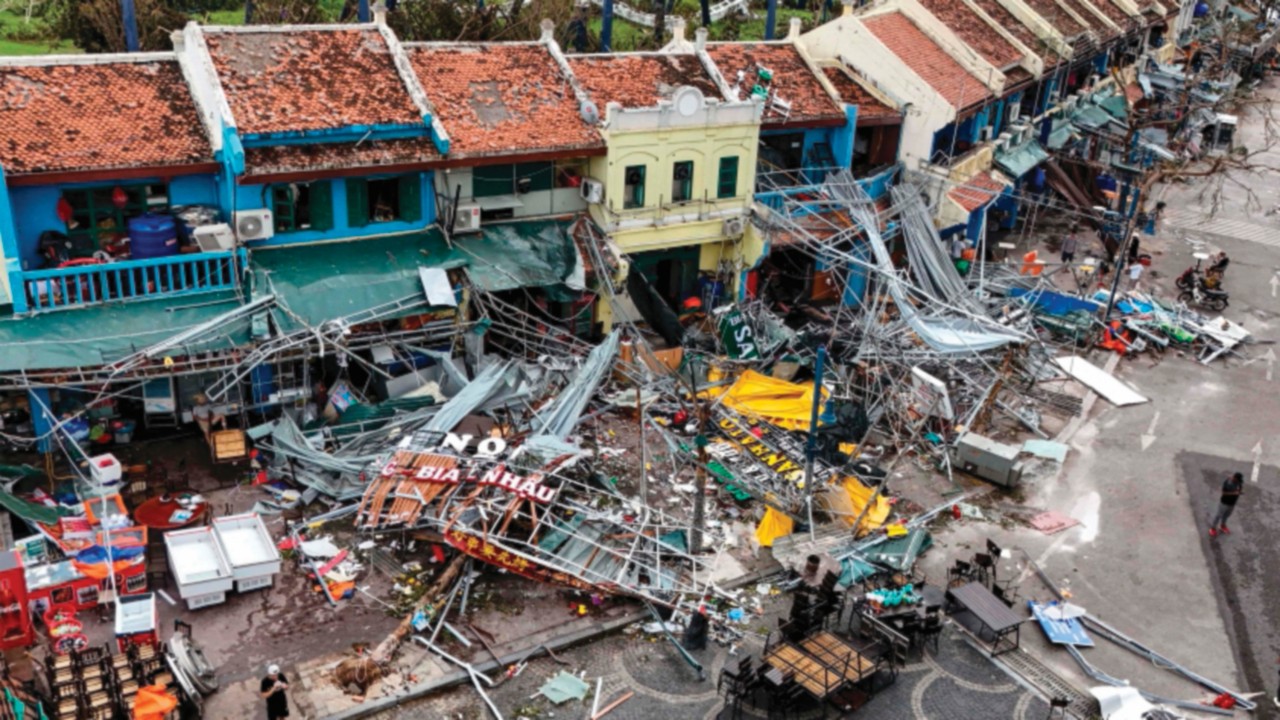 (FILES) This aerial picture shows damaged buildings and debris on a street after Super Typhoon Yagi ...